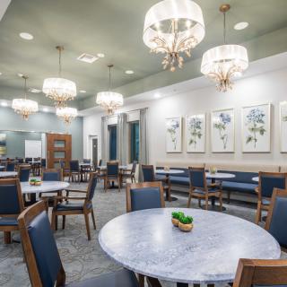 A modern dining area with elegant chandeliers and stylish furnishings.