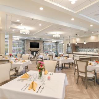 An elegant and modern dining area with neatly arranged tables and chairs.