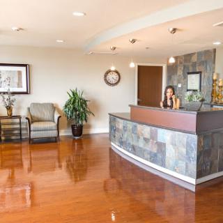 A modern reception area featuring a welcoming design with a front desk and seating.