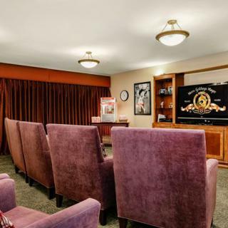 A cozy home theater with plush seating and a large screen for viewing movies.