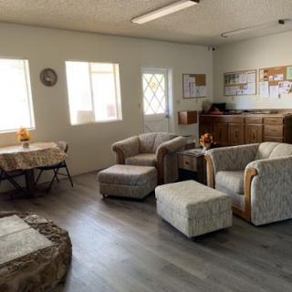 A cozy living room space featuring comfortable seating and ample natural light.