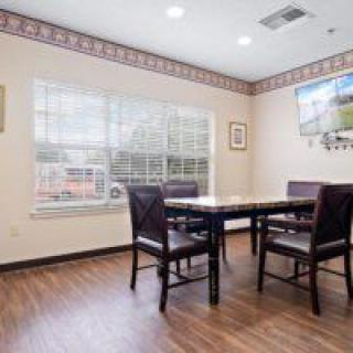 A small meeting room with a table, chairs, and a window.