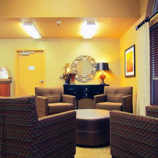 A cozy lounge area featuring comfortable seating, warm lighting, and modern decor.