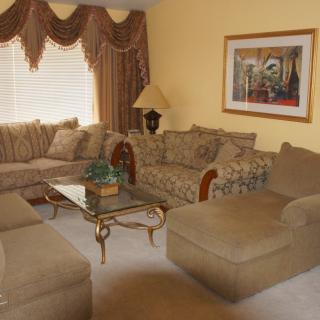 A cozy living room with a sectional sofa, coffee table, and elegant decor.