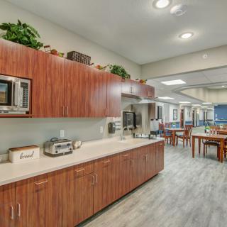 A modern kitchen with wooden cabinets and appliances on the countertop.