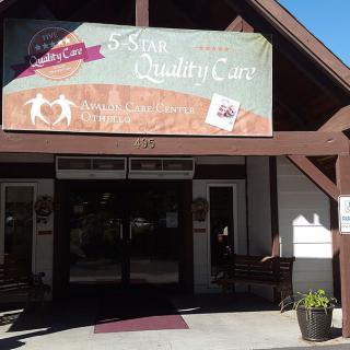 Entrance to a building with a large banner advertising quality care.