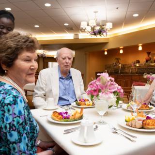 A group of people enjoying a meal together at a restaurant.