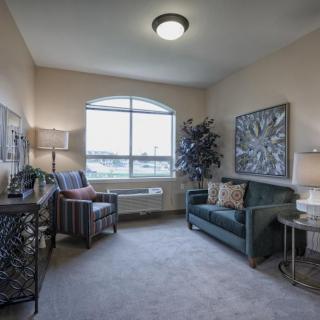 A cozy living room with comfortable seating and elegant decor.