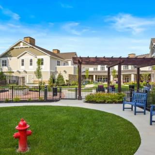 A well-maintained residential complex with a garden and outdoor seating area.