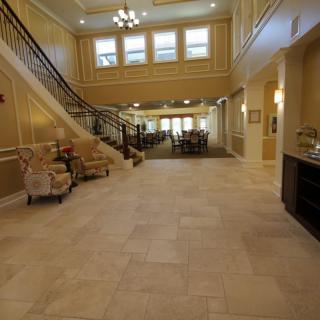 Luxurious lobby with elegant stairs and seating area.
