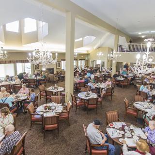A busy dining hall filled with people enjoying their meals.