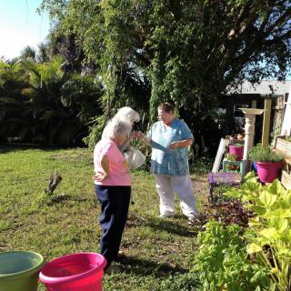 Two people enjoying a sunny day in the garden.