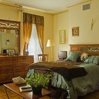 A cozy bedroom with classic wooden furniture and warm decor.