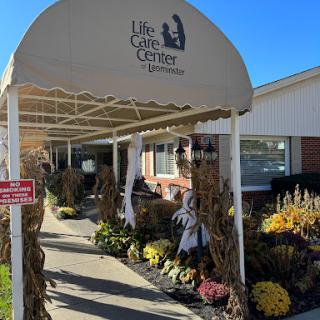 Entrance to the Life Care Center, adorned with autumn decorations and flowers.