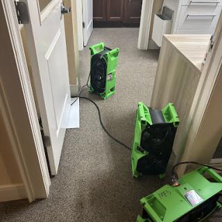 Air movers set up in an office hallway to aid in drying the carpet.