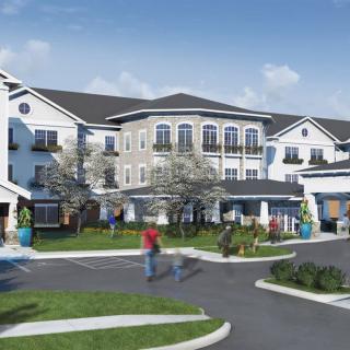 A modern residential apartment complex with landscaped surroundings and people walking.