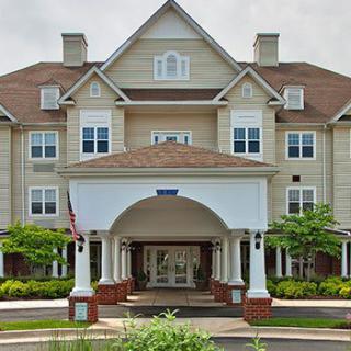 A picturesque residential building with a welcoming entrance and landscaped surroundings.