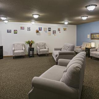 A spacious waiting room with comfortable seating and decorated walls.