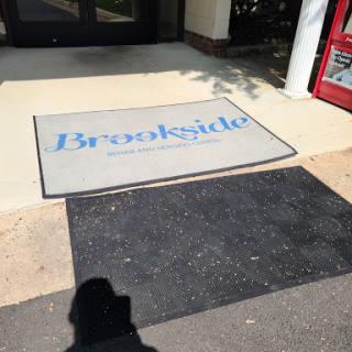 A welcome mat at the entrance of a building, featuring the name 'Brookside'.