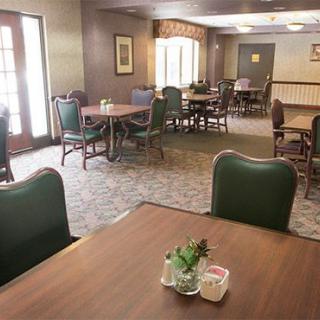 An empty dining area with neatly arranged tables and chairs.
