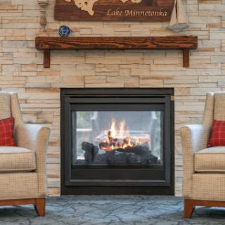 A cozy living room featuring a modern fireplace and comfortable armchairs, perfect for relaxation.