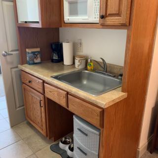 Compact kitchen setup with wooden cabinets and modern appliances.