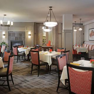 A cozy and elegant restaurant dining area with well-set tables.