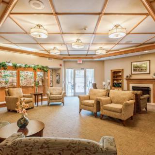 A cozy and spacious living room interior with comfortable seating and elegant decor.