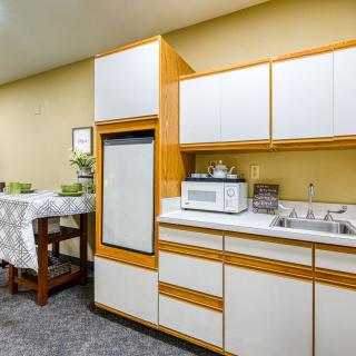 A retro-style kitchen with wooden cabinets and modern appliances.