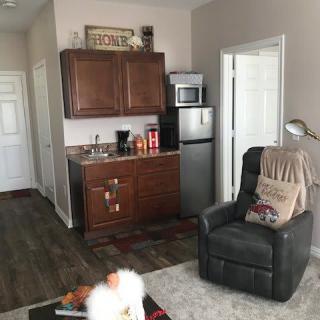 A cozy living space with a kitchenette and recliner.