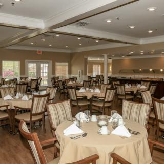 An elegant dining room with neatly arranged tables and chairs, ready for service.
