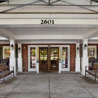 Main entrance of a building with benches on both sides.