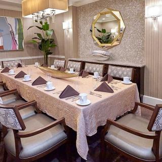 A luxurious dining room with an elegantly set table, complete with napkins and fine decor.
