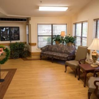 Cozy living room with comfortable seating, plants, and natural light.