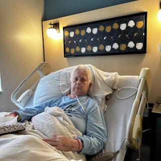 A patient resting in a hospital bed, receiving care and recovery.