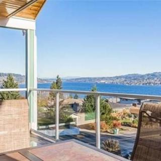 A scenic balcony view overlooking a lake and mountains.