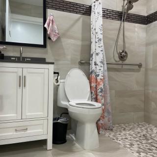 A modern bathroom with a toilet, sink, and shower area.
