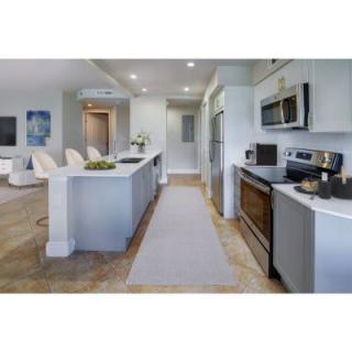 A modern kitchen with stainless steel appliances and an open floor plan.