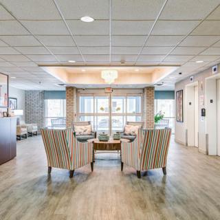A welcoming lobby area featuring comfortable seating, elegant lighting, and access to elevators.
