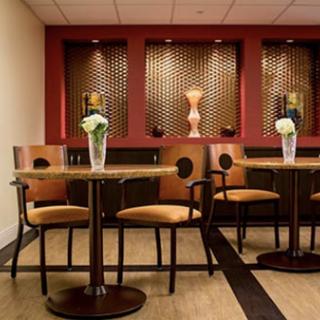 A cozy and modern lounge area featuring elegant furniture and decorative elements.