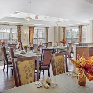 A well-decorated dining area with neatly arranged tables and chairs, featuring a cozy and inviting atmosphere.