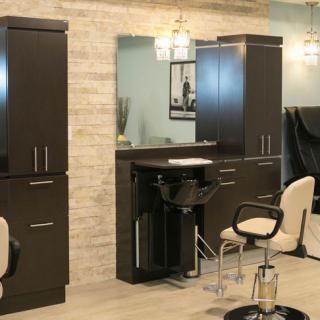 A modern hair salon interior with chairs, mirrors, and stylish lighting.