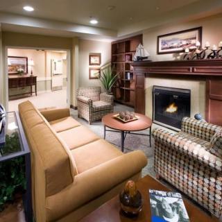 A cozy, modern living room with a fireplace and comfortable seating.