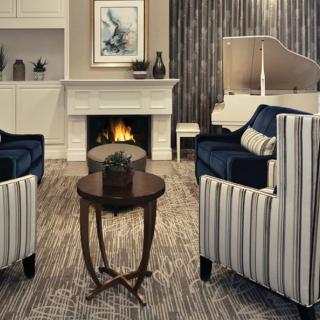 A cozy living room with a warm fireplace and stylish furniture.