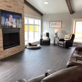 A spacious and inviting living room featuring a modern design with a fireplace and large windows.