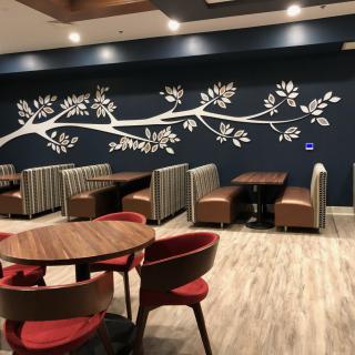 A modern restaurant interior featuring stylish seating and decorative wall art.