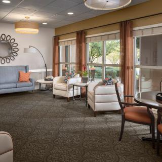 A cozy living room with comfortable seating and large windows.