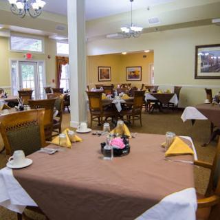A well-arranged dining space featuring neatly set tables and a warm atmosphere.