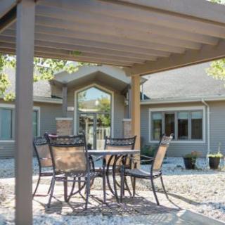 A cozy outdoor seating area under a shaded canopy, perfect for enjoying the fresh air.