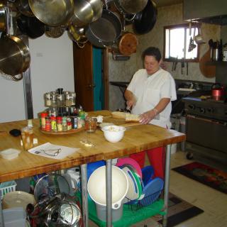 A person preparing food in a well-equipped kitchen.